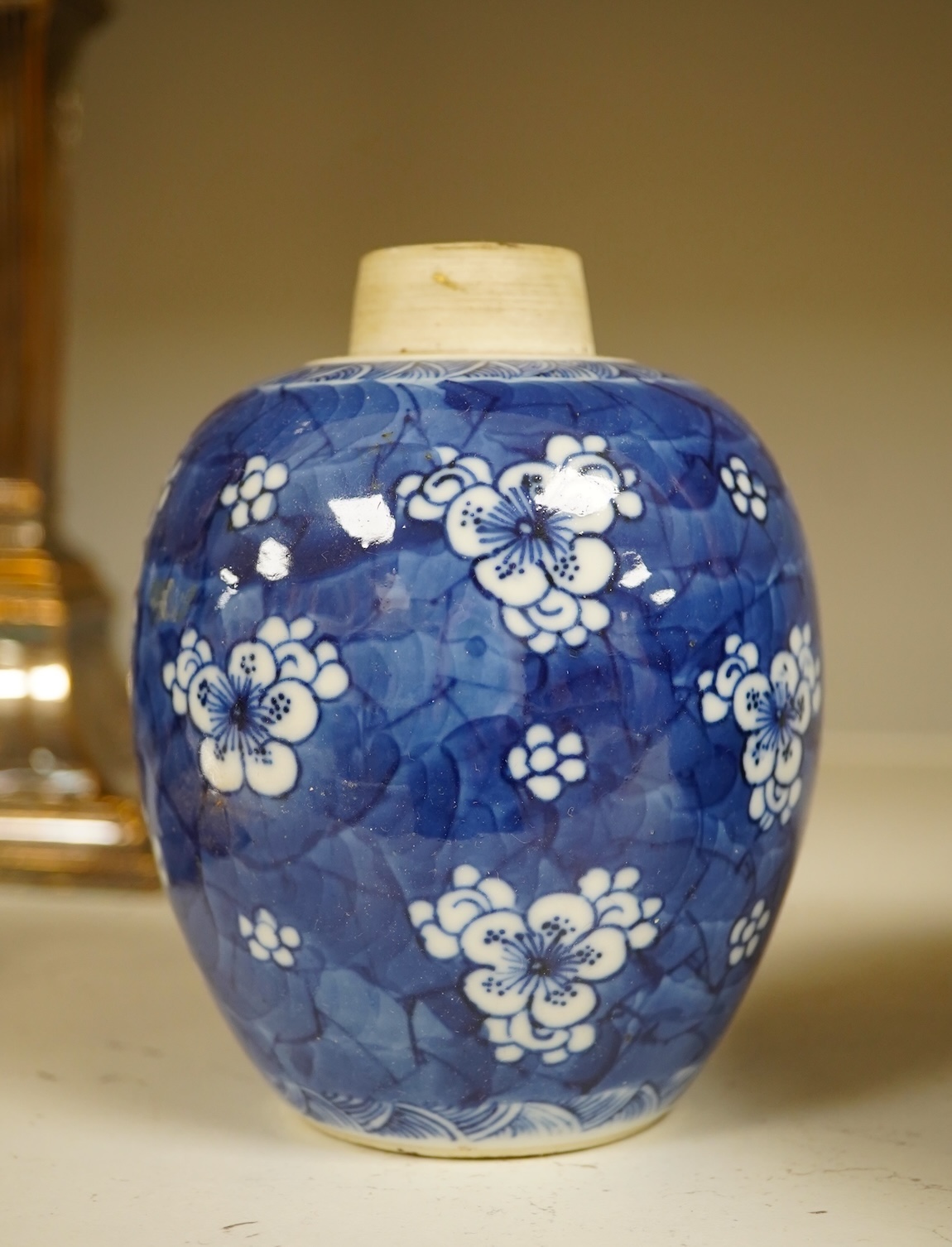 A Chinese powder blue bowl, early 18th century and a Chinese blue and white prunus jar - tallest 13cm. Condition - fair